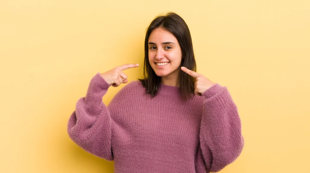 smiling confidently pointing own broad smile positive relaxed satisfied attitude